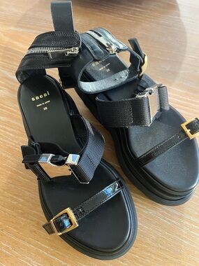 sacai Black Leather & Webbing Sandals with Mixed Metal Buckles. Size 38. NWOT.